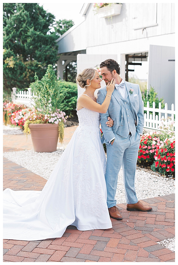 Bride and groom embracing during golden hour coastal wedding