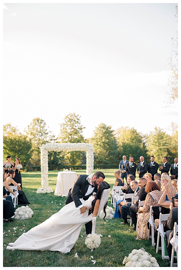 groom dips bride down aisle