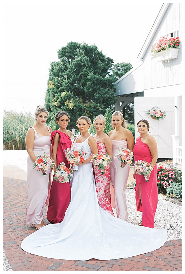 Bridesmaids and groomsmen posing at coastal NJ wedding venue
