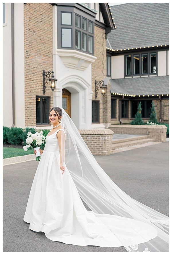 Bride and groom portrait in front of the venue's classic building facade
