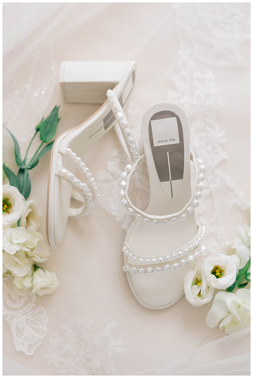 Eagle Oaks wedding flat lay with engagement rings, invitation suite, and bridal details styled on a neutral background