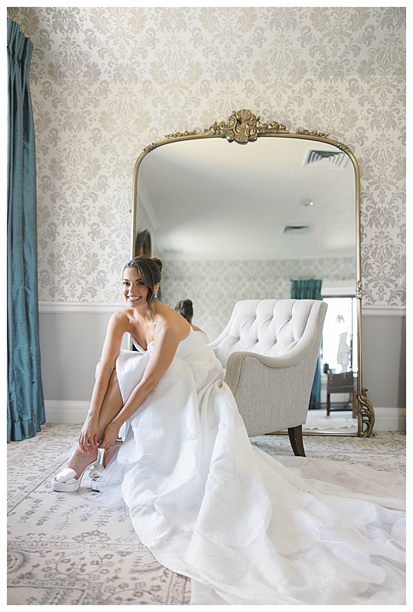 Sarah putting on her wedding dress at Fiddler’s Elbow