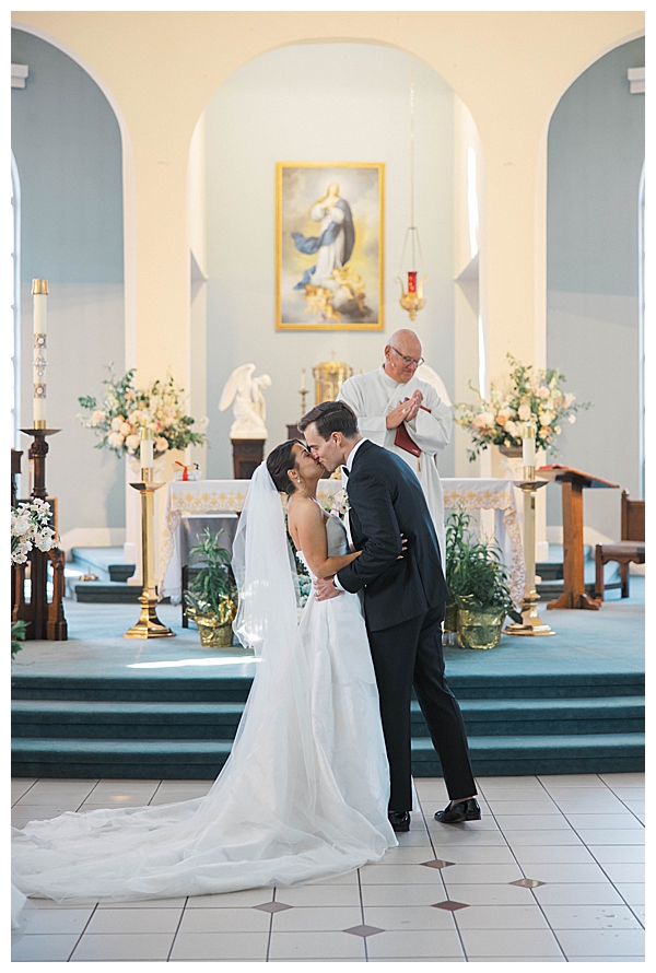 bride and groom first kiss church ceremony