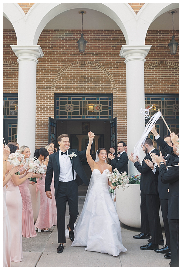 bride and groom walking out of church