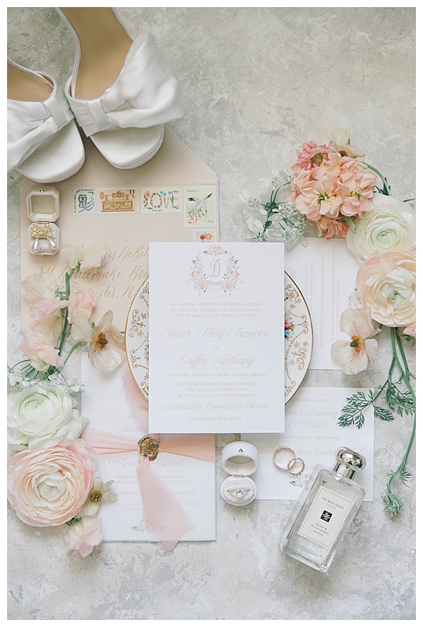 Wedding invitation flat lay with blush florals at Fiddler’s Elbow