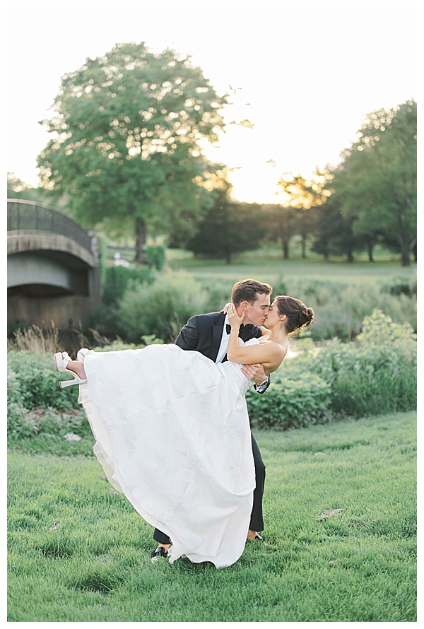 Bride and groom walking at sunset in Fiddler’s Elbow gardens