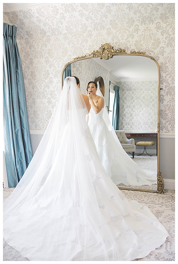 Sarah looking in mirror while getting dressed at Fiddler’s Elbow