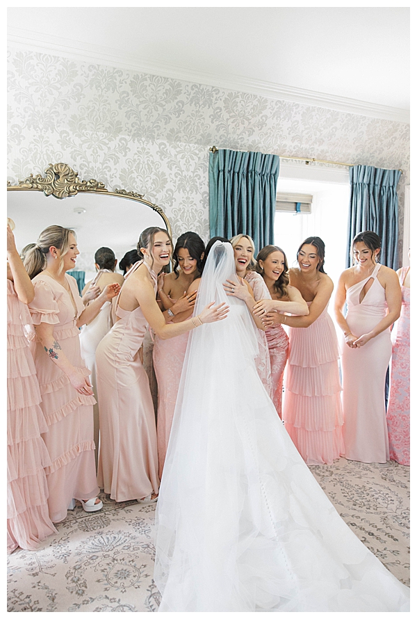 bride hugging bridesmaids