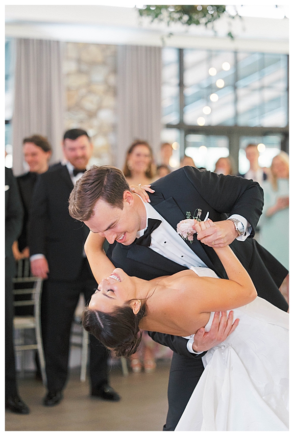 groom dips bride on dance floor