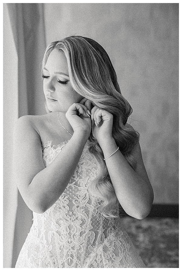 Bride getting ready in a bright bridal suite