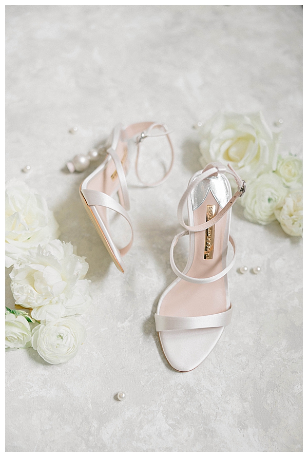 Bridal detail flatlay with white and green florals at The Tilling House Eatontown wedding