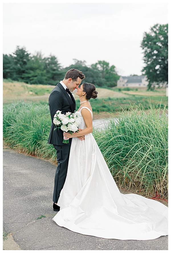 Hannah and Jake laughing together during their wedding day portraits