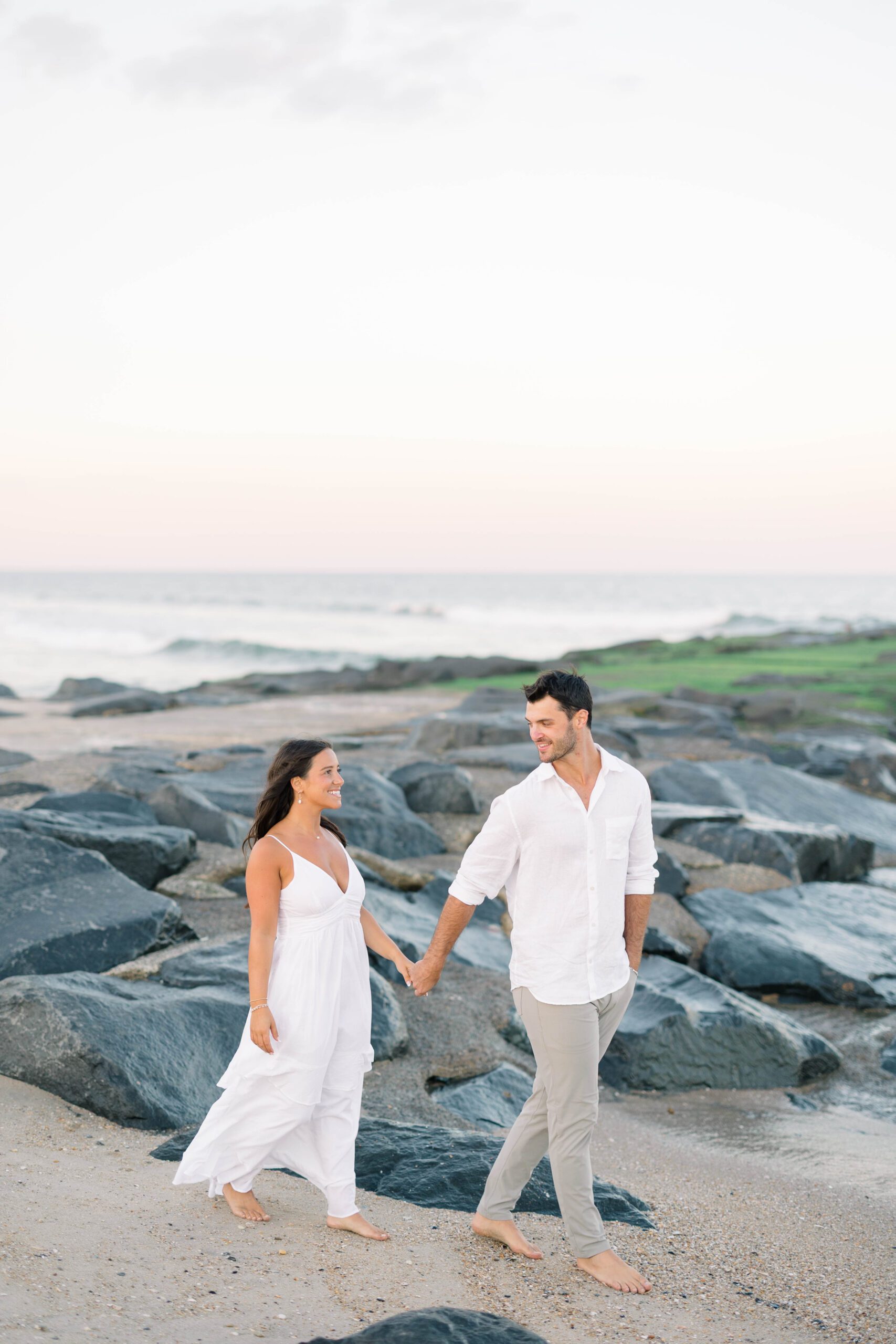 Jersey Shore golden hour engagement portrait with warm light reflecting off the ocean