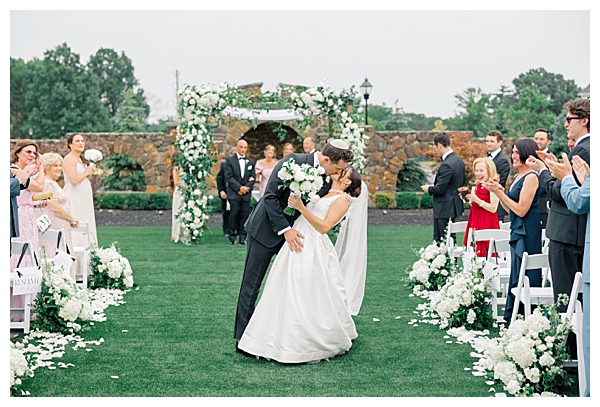 Grand floral chuppah adorned with white blooms and greenery at the NJ black tie wedding