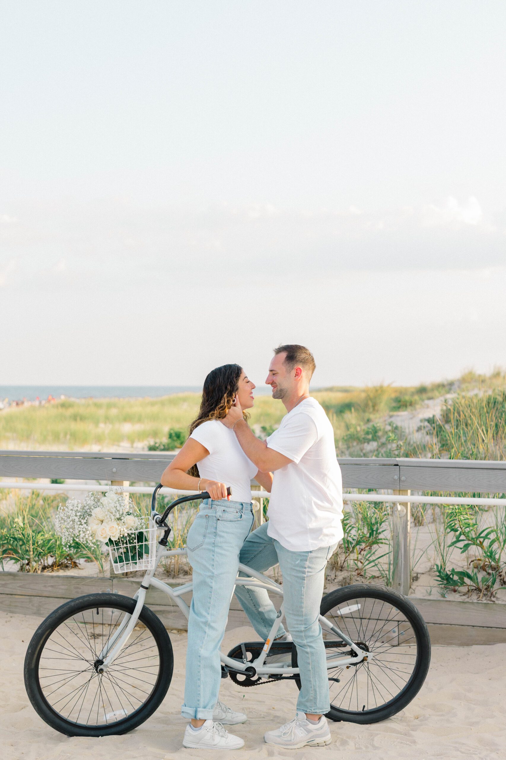 Rachel and Ben riding bikes together during their Long Beach Island engagement session