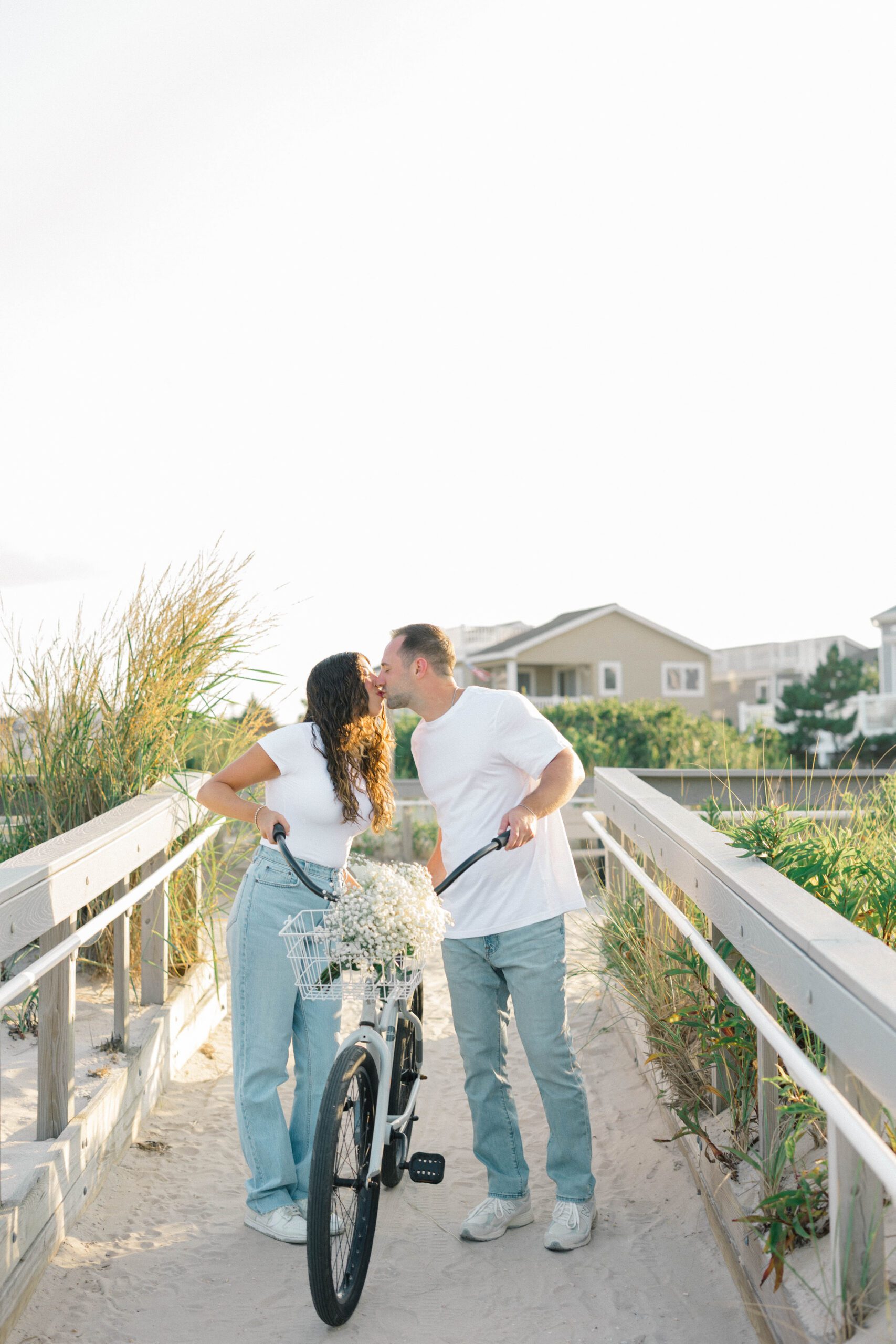 Long Beach Island engagement photographer Rachel and Ben biking through beach town streets