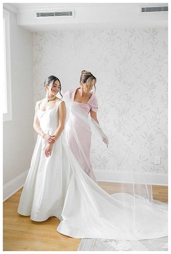 Mom helping bride with veil 