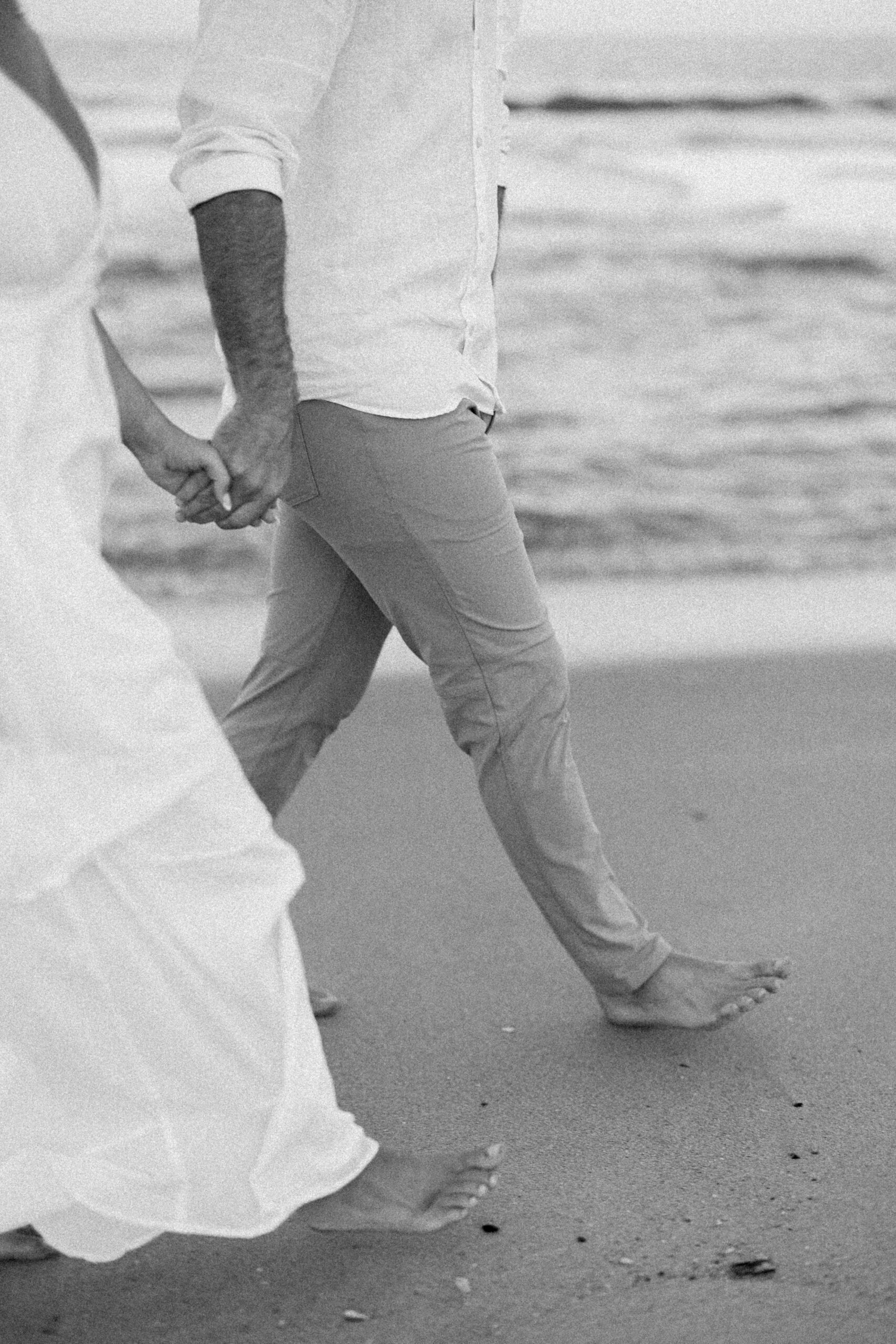 New Jersey beach engagement photos of couple embracing near the waves at sunset