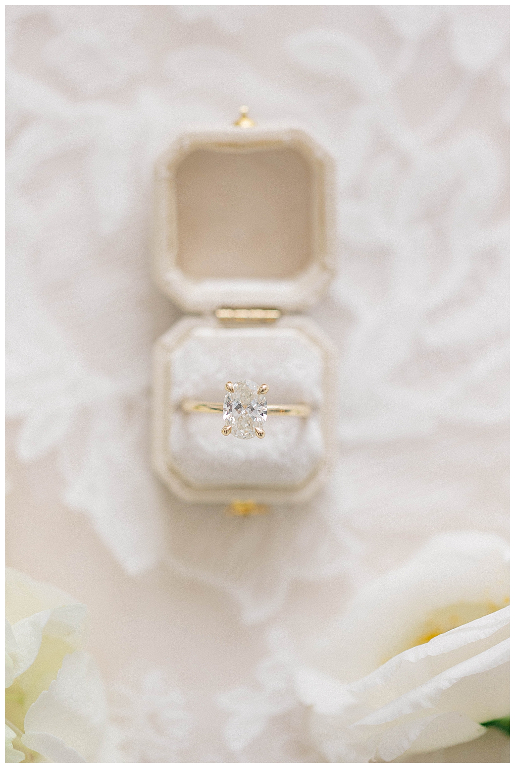 Flat lay of bridal accessories including earrings, perfume, and a lush wedding bouquet at a New Jersey wedding