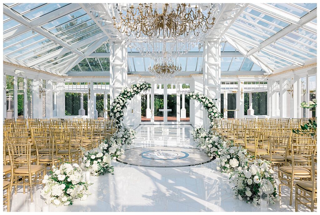 Outdoor wedding ceremony at Eagle Oaks Country Club in Farmingdale, NJ, with guests seated under a floral arch