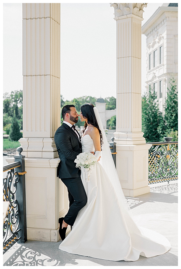 Bride in veil standing by stone window at Legacy Castle New Jersey wedding