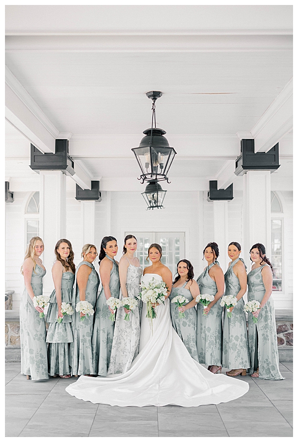 bridesmaids in blue floral dresses with white bouquets at the Ryland Inn