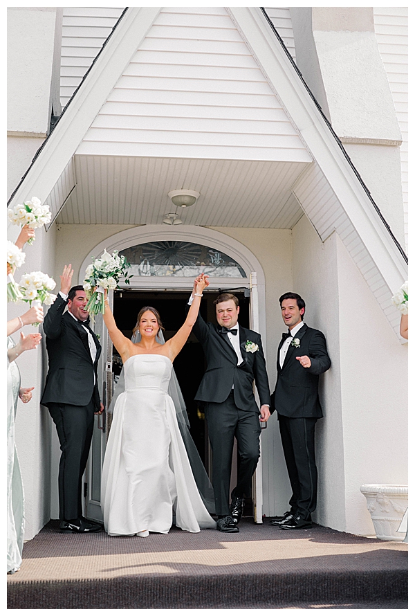 bride and groom walking out of the Church