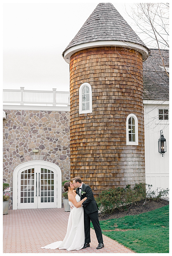 bride and groom kissing in front of silo at the Ryland Inn