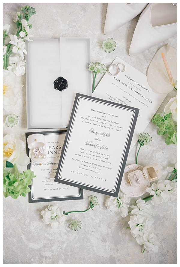 Wedding invitation suite flat lay with light blue and white details for a Ryland Inn spring wedding