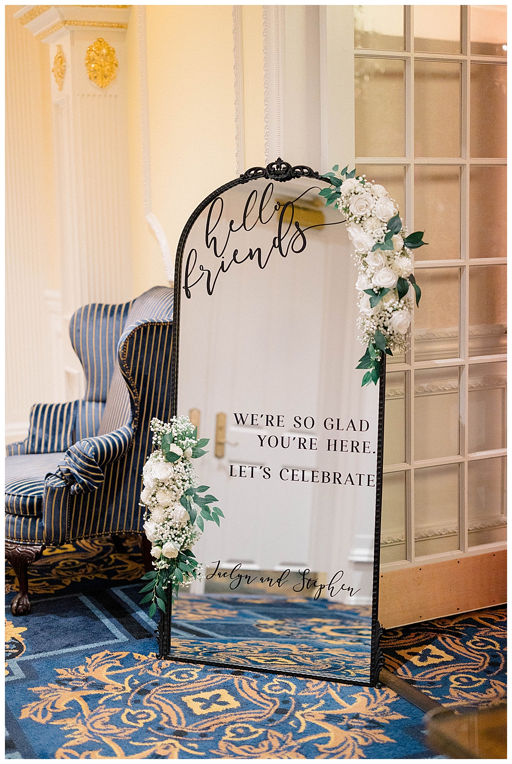 Wedding seating chart displayed on a large mirror at the Eagle Oaks Country Club reception entrance