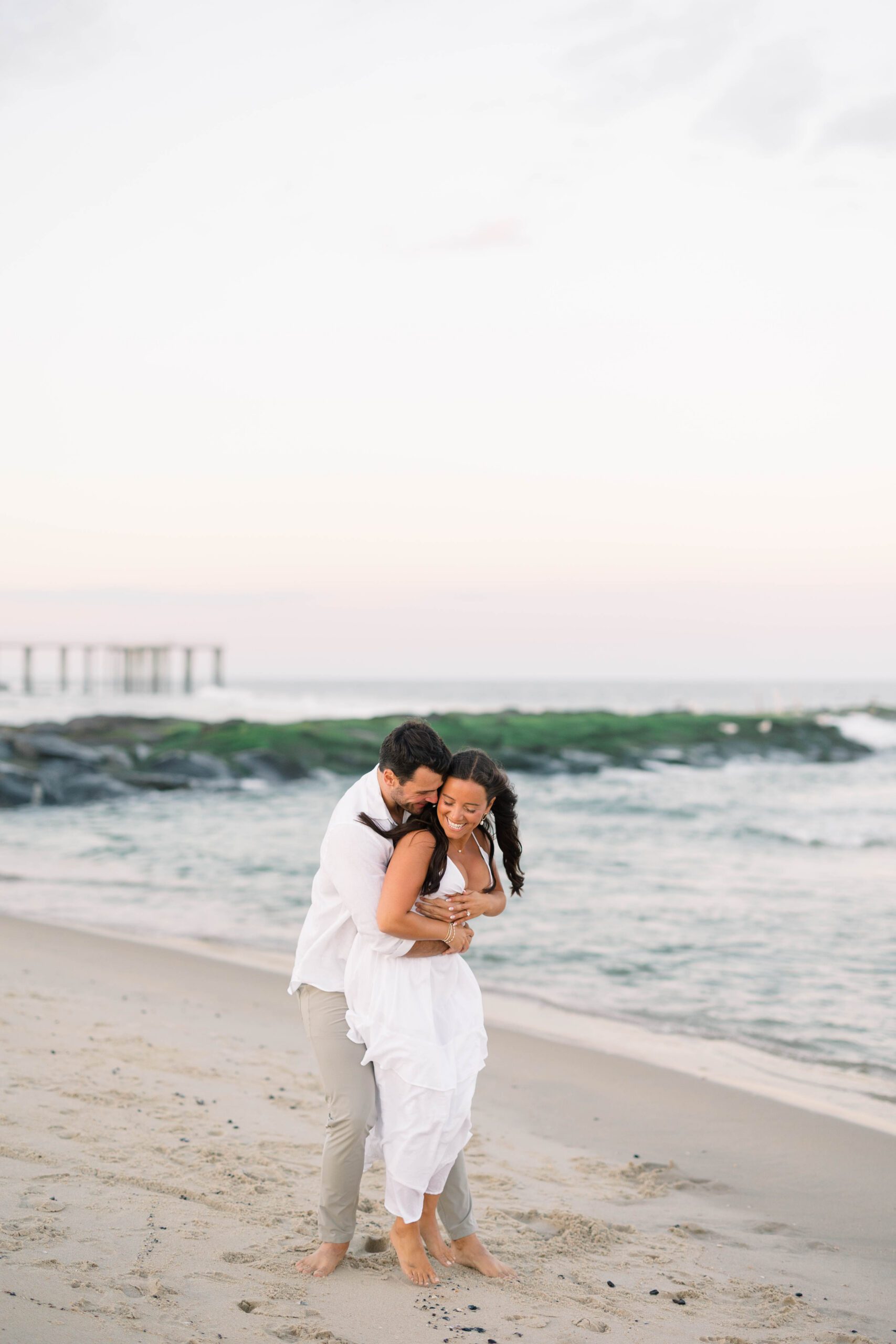 Spring Lake beach engagement sunset portrait with glowing sky reflecting on the wet sand
