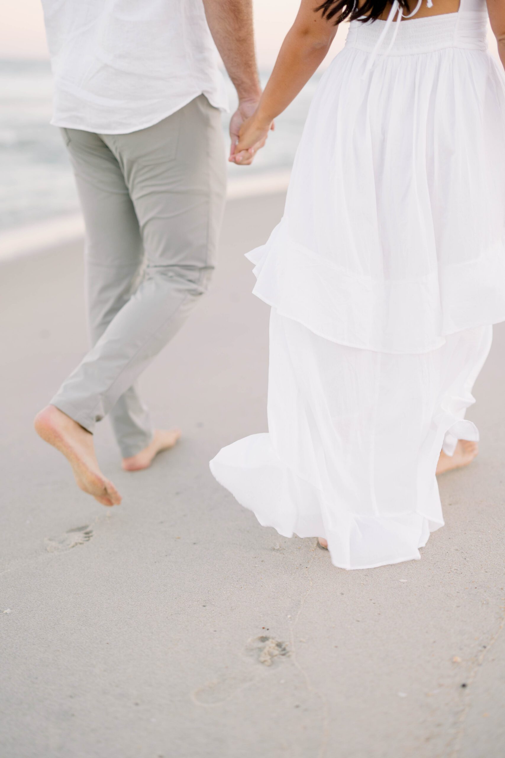 Spring Lake engagement session sunset portraits with peach and amber skies over the Atlantic
