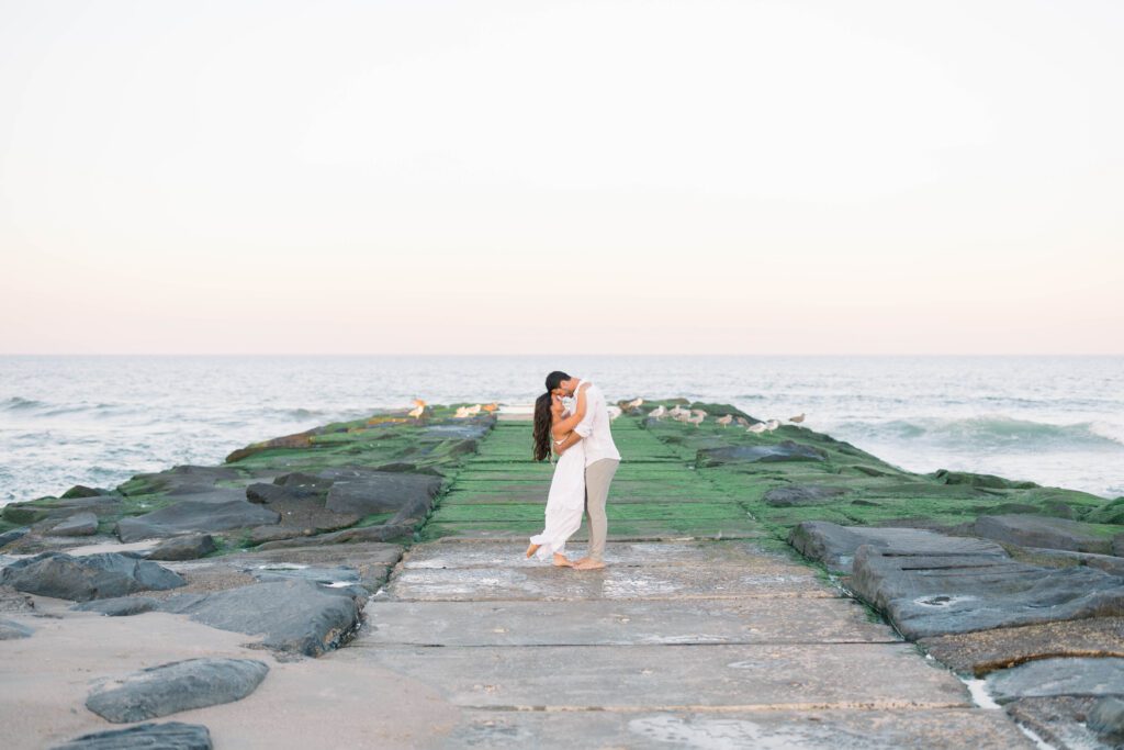 Spring Lake NJ couple beach portraits at golden hour with soft ocean light