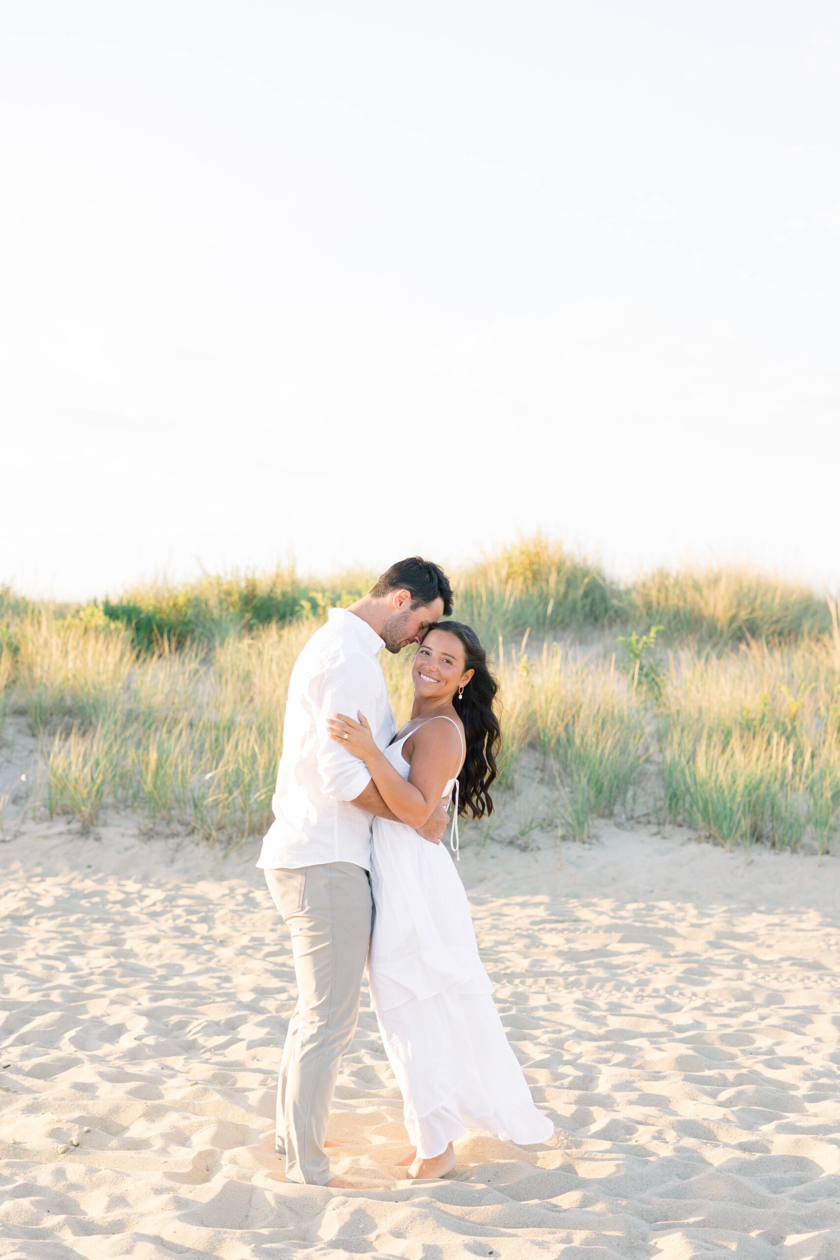 Steph and Tyler's Spring Lake NJ beach engagement session — couple sharing a quiet moment by the water