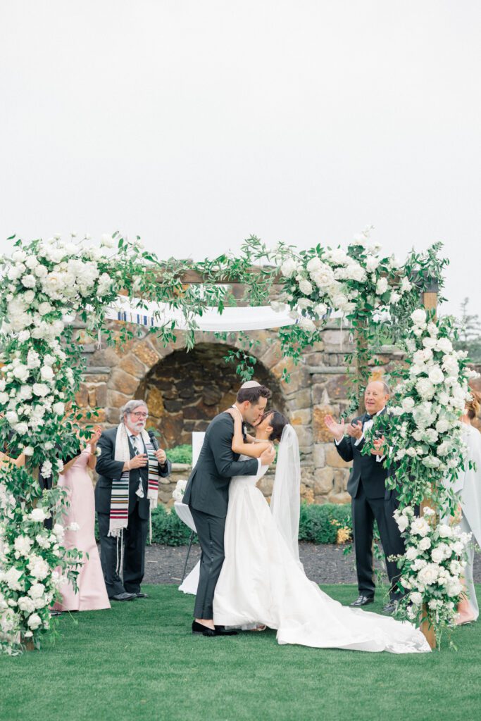 Bride and groom sharing their first kiss as husband and wife during the ceremony