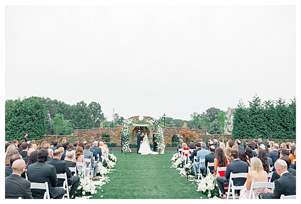 Large floral chuppah set up in the back of the venue for the outdoor ceremony