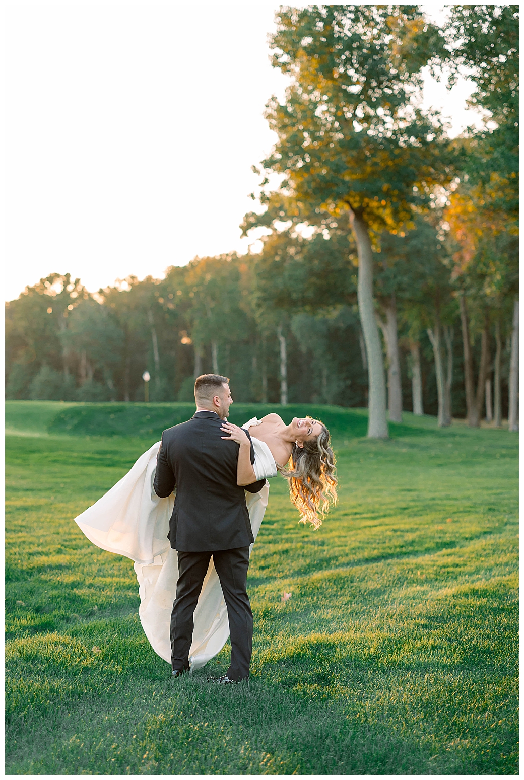 Bride and groom holding hands during couples portraits in the garden at their New Jersey wedding venue