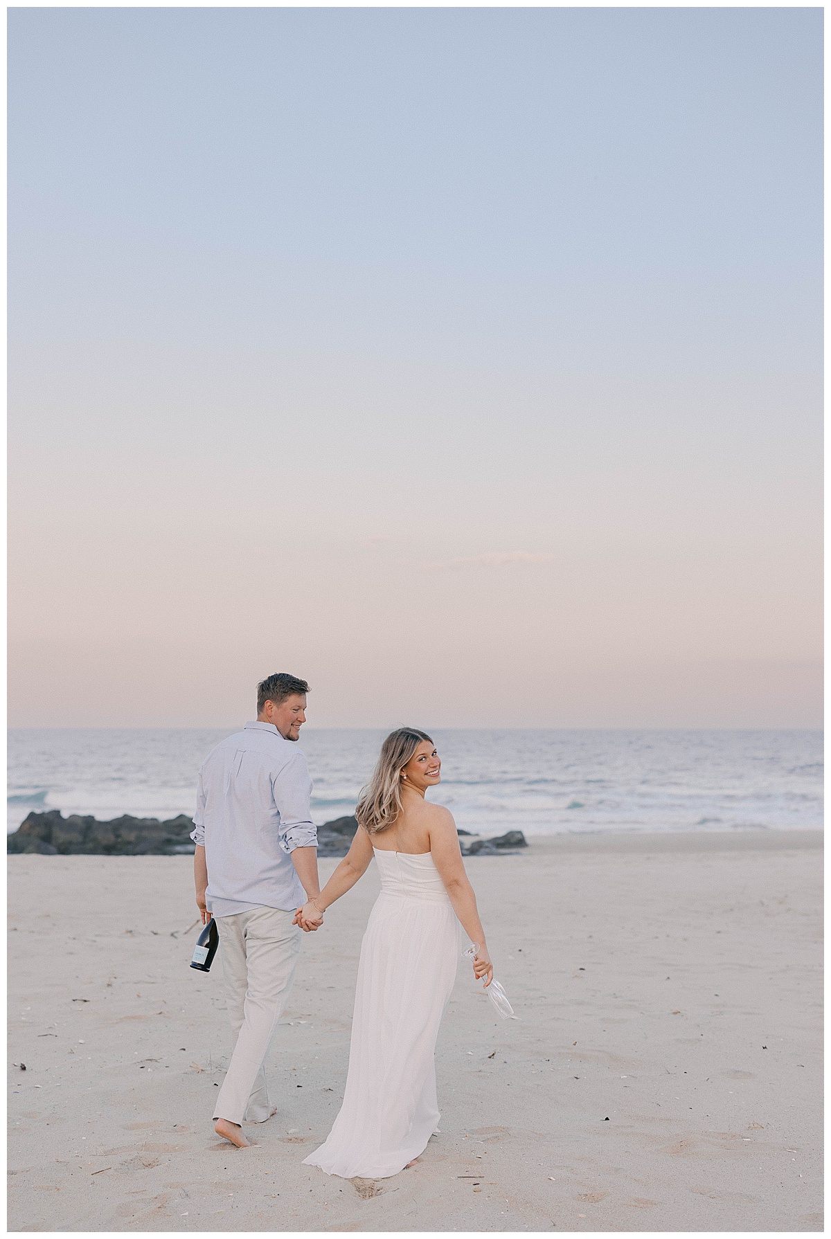 Sea Girt engagement photographer captures Peter and Amanda laughing on the shoreline at sunset