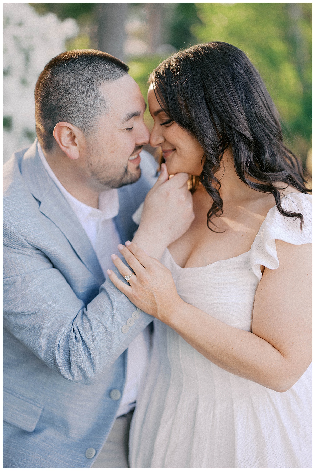 Engagement couple in dappled sunlight among the trees at Divine Park Spring Lake