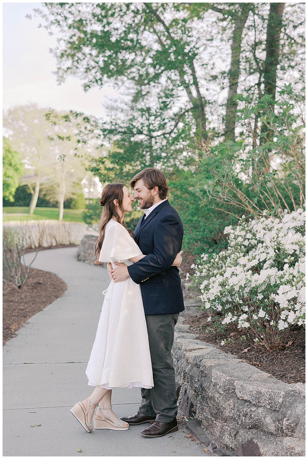 Christie and Kyle posing on the wooden bridge during their Divine Park engagement session in New Jersey