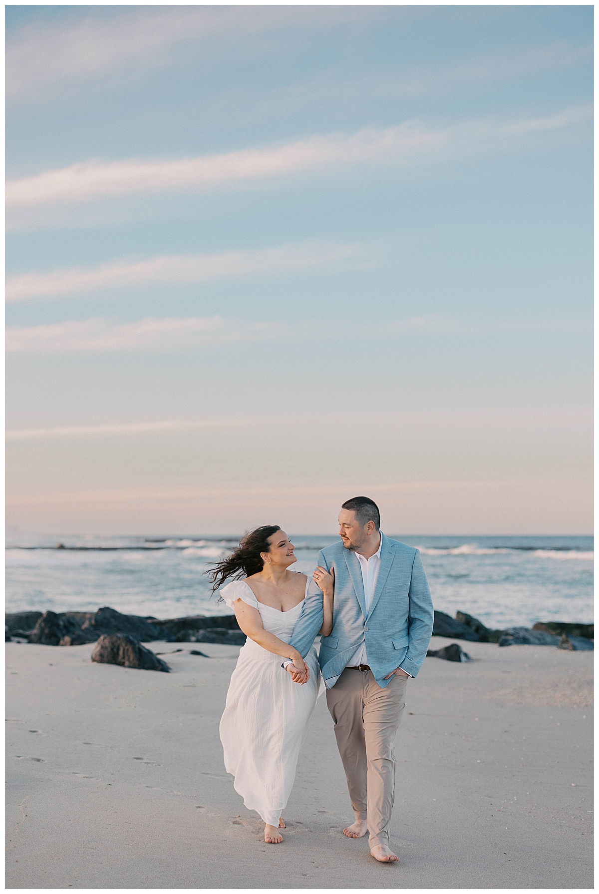 Golden hour engagement portraits on the Jersey Shore with warm glowing light