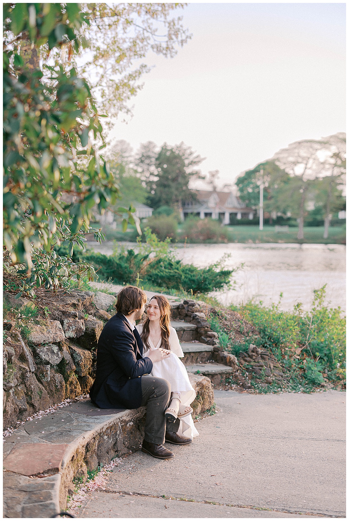 Christie and Kyle holding each other close in the last light of golden hour at Divine Park