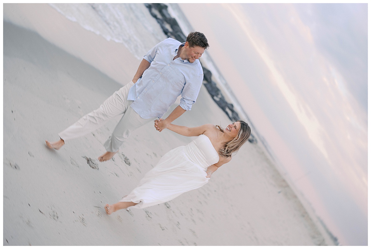 Amanda and Peter walking the shoreline at golden hour in Sea Girt NJ