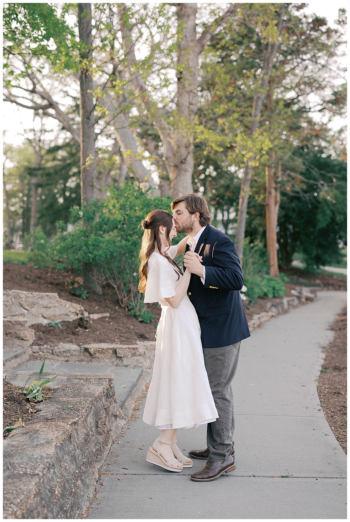 Christie in a flowing dress walking through Divine Park with cinematic golden backlight