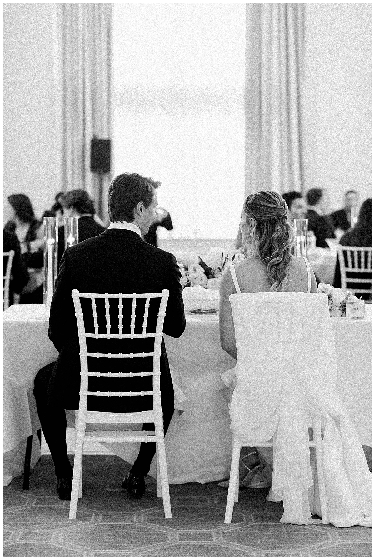bride and groom listening to speeches 